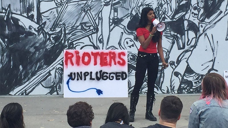 A Riot employee speaking to her colleagues through a megaphone