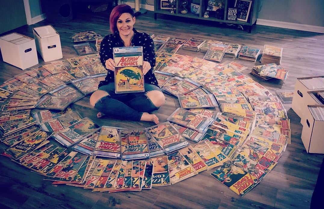 Danielle Smith with her collection of Action Comics, including the first appearance of Superman..