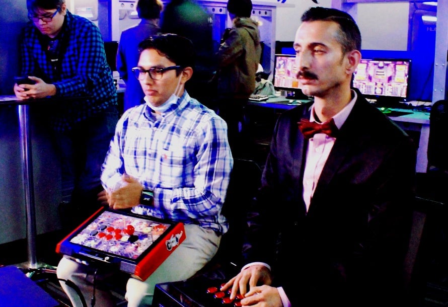Jose Ramon Navarrete (R) plays King of Fighters.