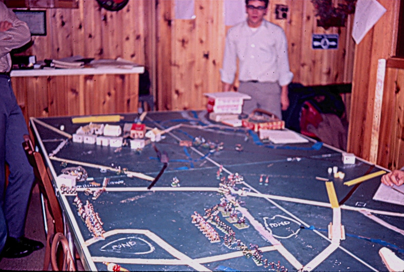 Dave Arneson’s friends gaming on his ping pong table.