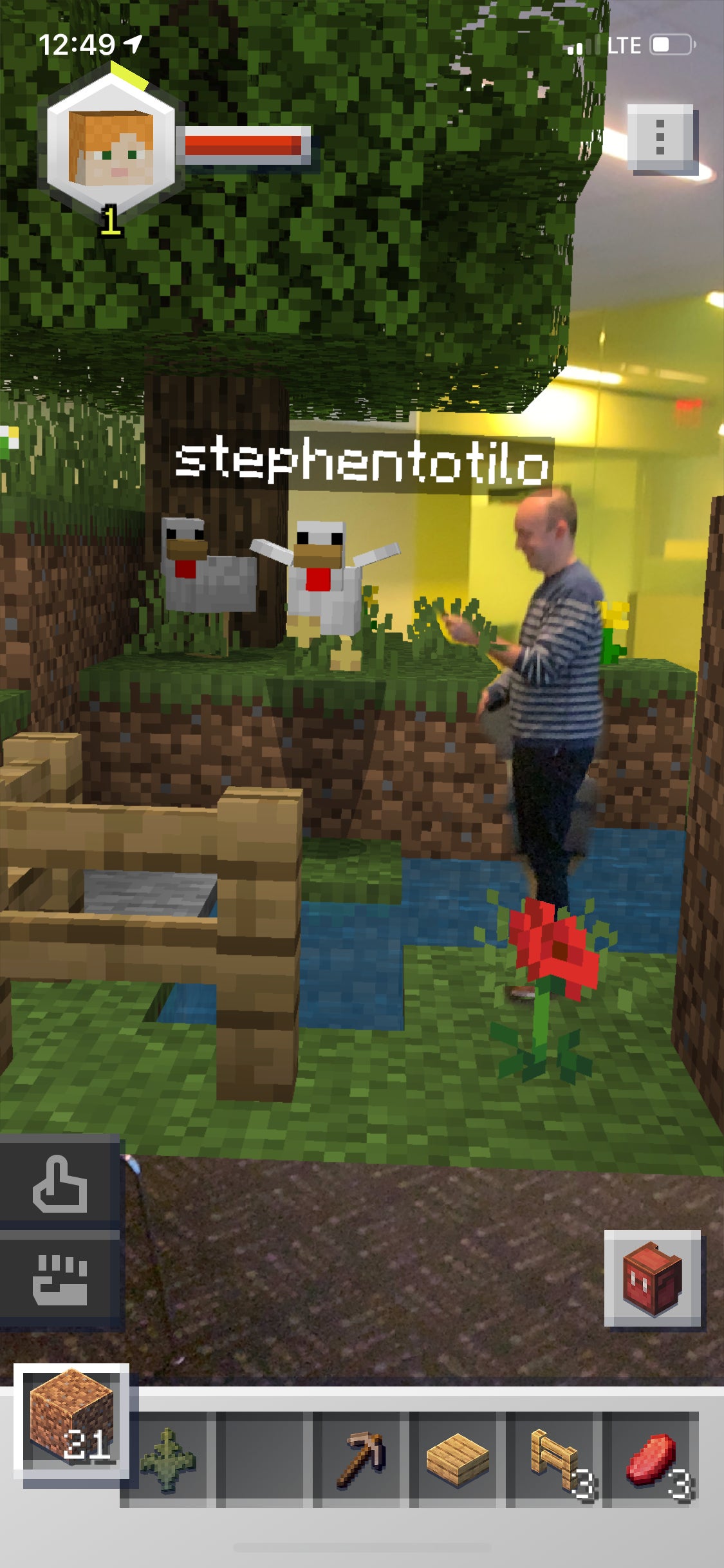 Your author interacting with one of the pre-made builds that players can plop into the real world and then collaboratively build or destroy.