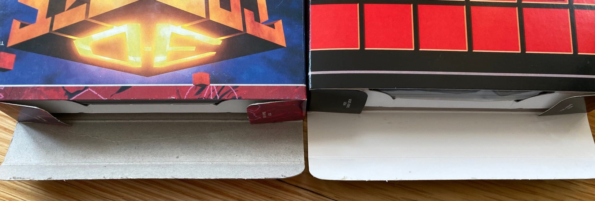 An authentic Nintendo game box (left) and a box for a homebrew game. Note that the authentic box is printed on grey cardboard with a fibrous texture to it, while the aftermarket game (like most fakes) is printed on bright white card stock. (Note that some official Game Boy Advance games did come in white boxes like this.)