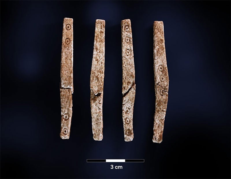 The four sides of the single dice found at the site. You can see numbers at each end of the “stick”.