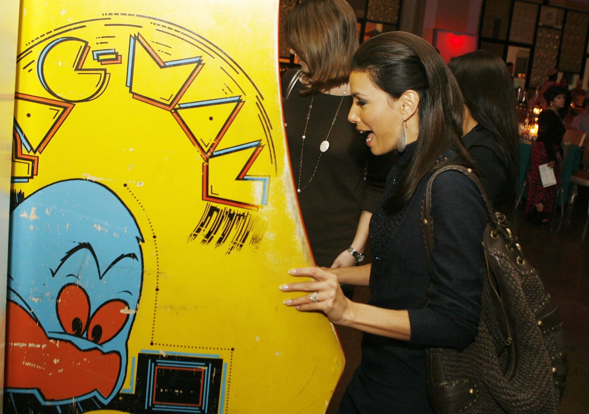 Actress Eva Longoria plays a vintage Pac-Man machine in 2007.