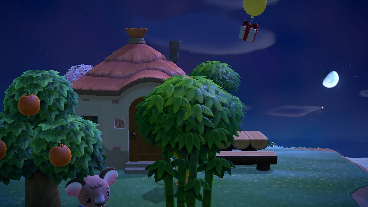 A balloon with a gift attached drifts over a house in Animal Crossing: New Horizons.