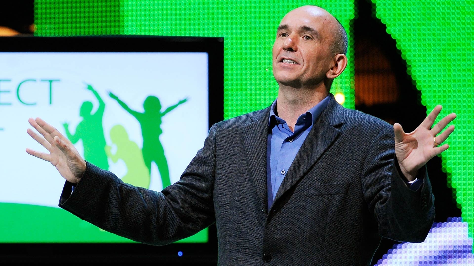 Peter Molyneux stands on stage at an Xbox show.