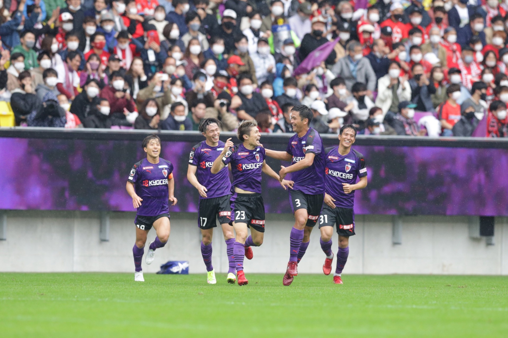 Kyoto Sanga players celebrate retaining their top flight status earlier this year
