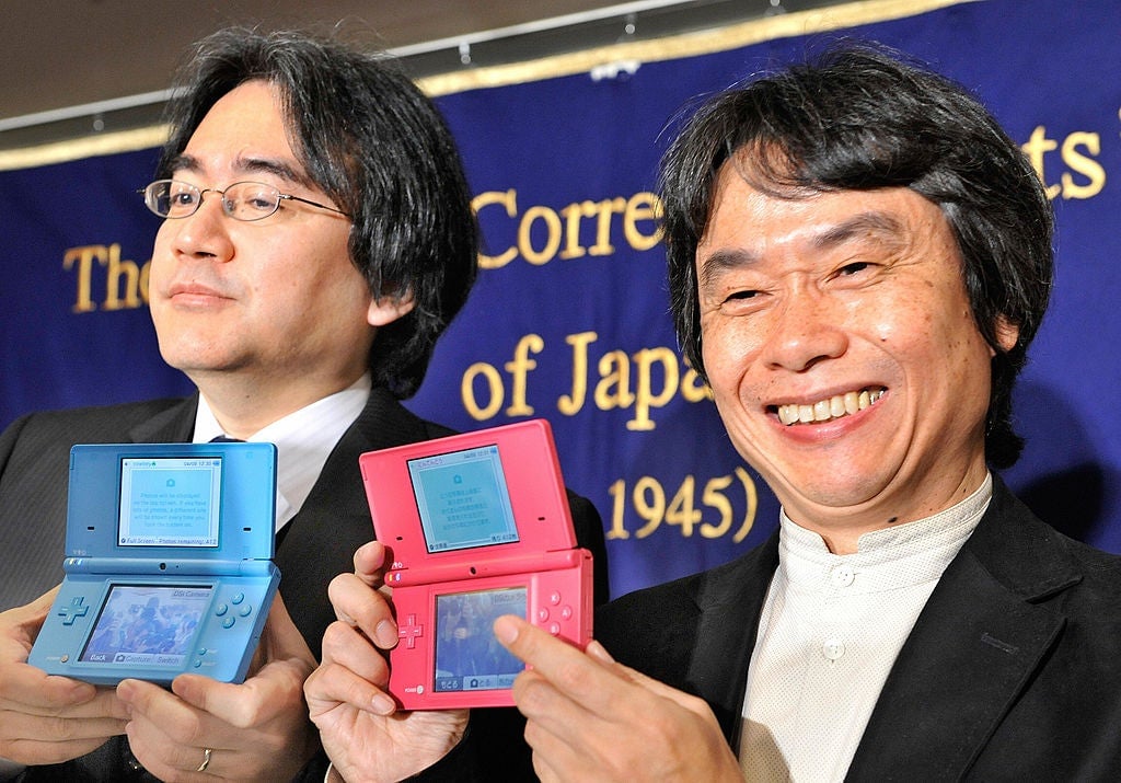 Nintendo president Satoru Iwata (L) and games developer Shigeru Miyamoto (R), known for his work on Super Mario, Zelda and many of Nintendoâs popular products, show a Nintendo DSi during a press conference at the Foreign Correspondentsâ Club in Tokyo on April 9, 2009.