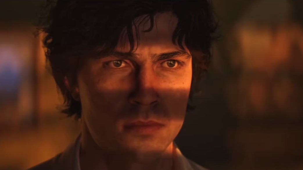 A man looks through the shades in his office.