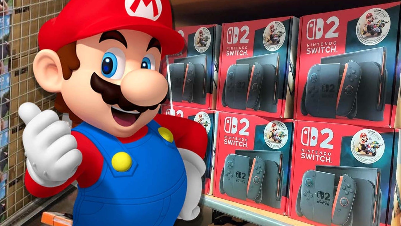 Mario gives the thumbs up in front of Switch 2s on a shelf.