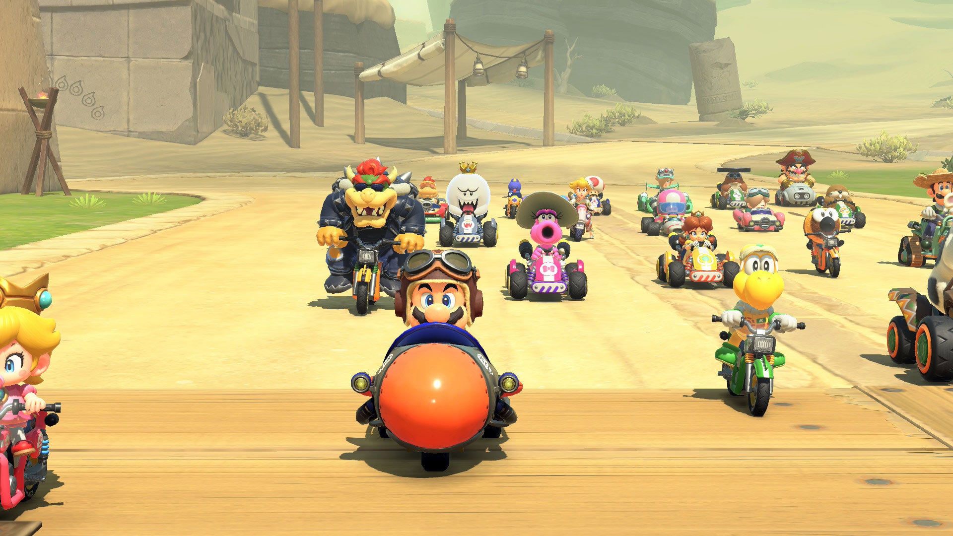 A screenshot of Mario Kart World. Baby Daisy is celebrating after crossing the finish line.