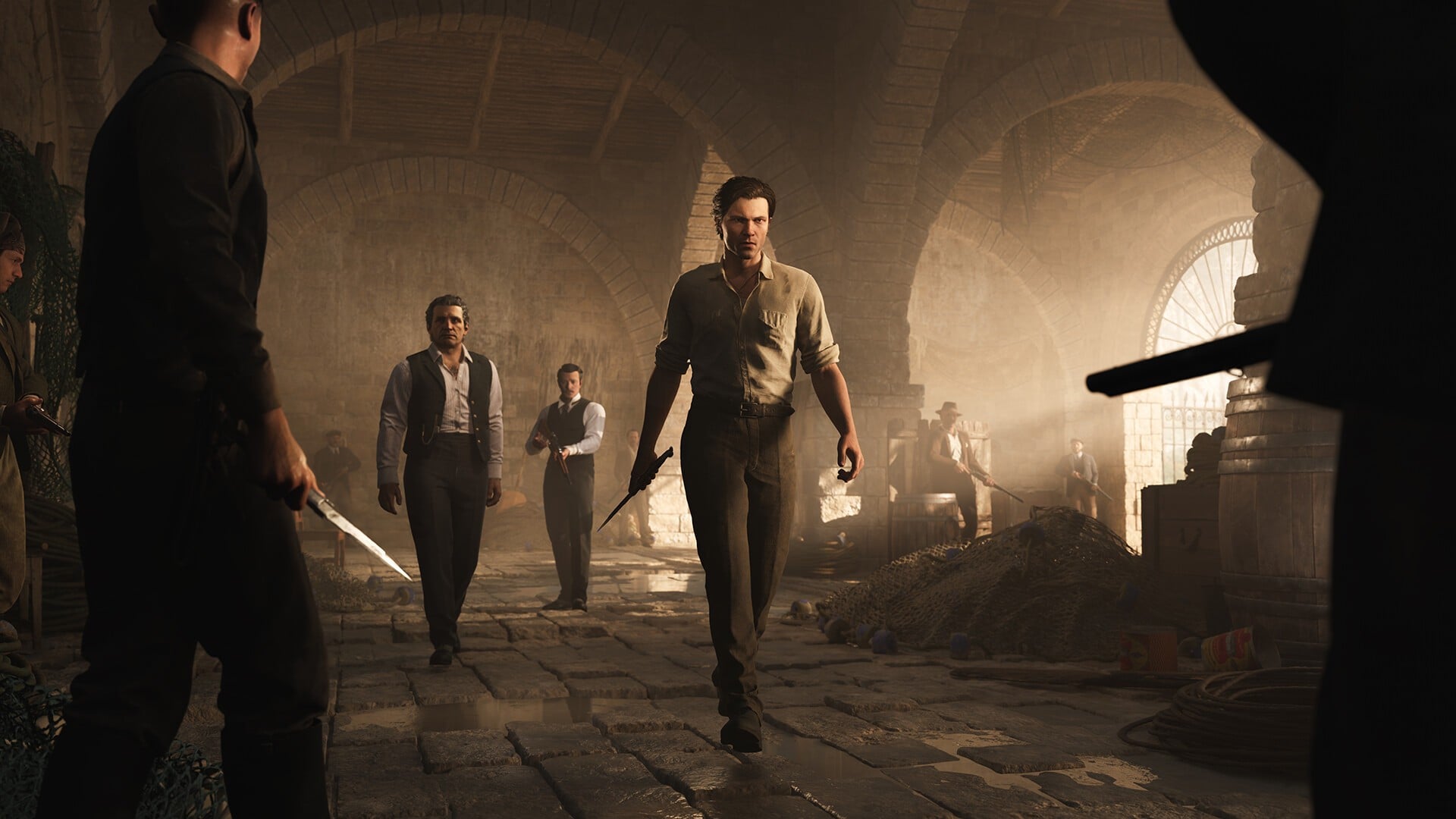 A man strides with intent (and, importantly, a knife in his right hand) toward other men brandishing knives and guns.