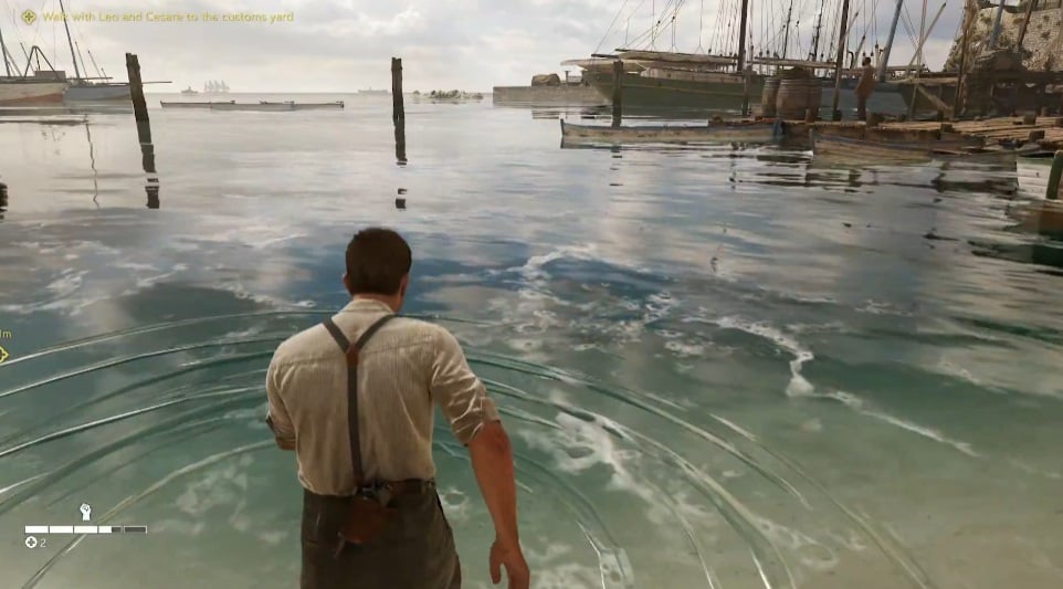 An image shows a man walking in water.