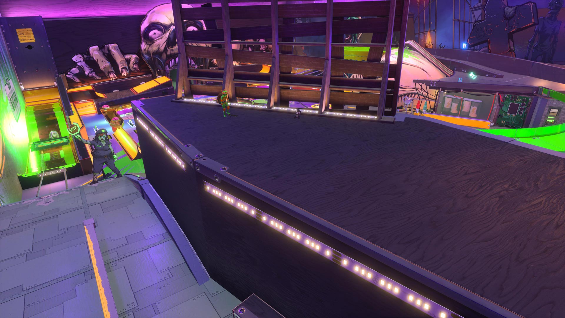 Michelangelo and a plush inside a giant pinball machine.