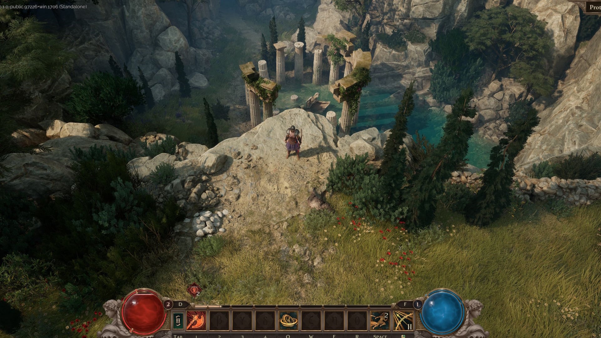 A grassy area, with a circle of ruined pillars below.