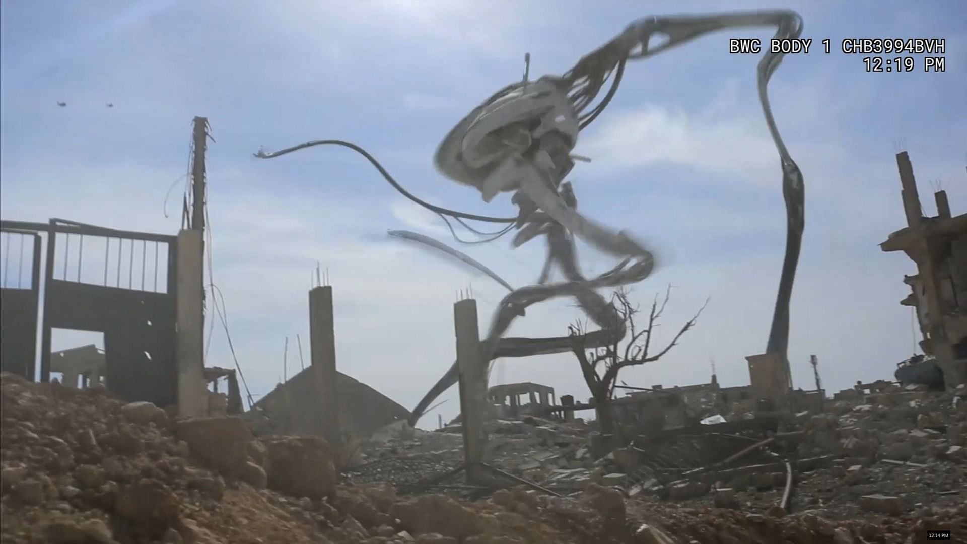 A tripod stomps through ruins.