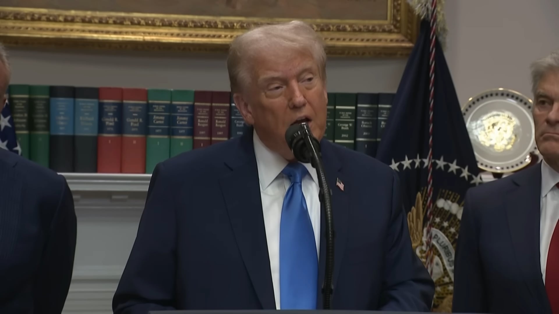 Trump talking into a microphone