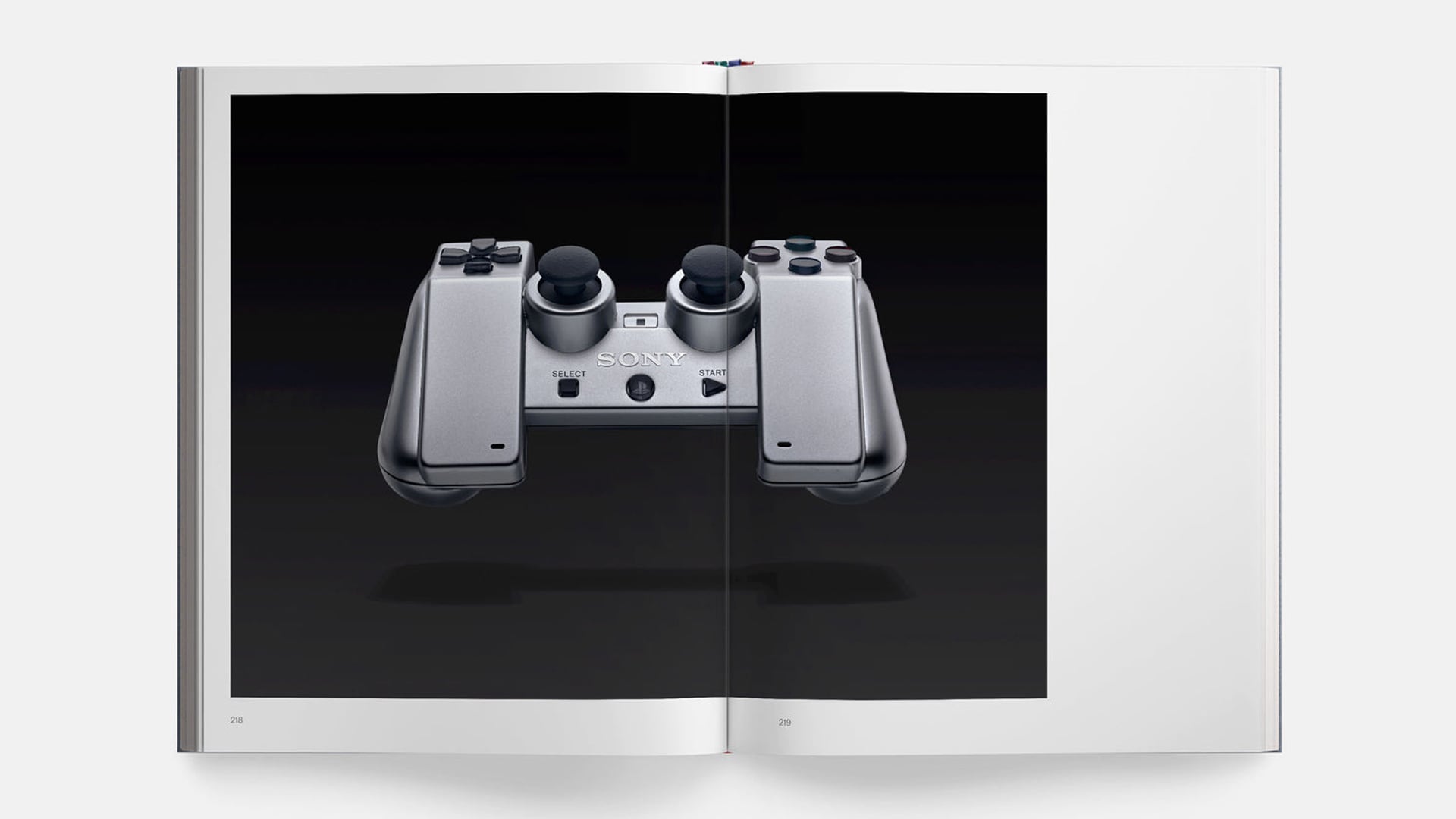 An image of a photobook shows a rare PlayStation controller concept.