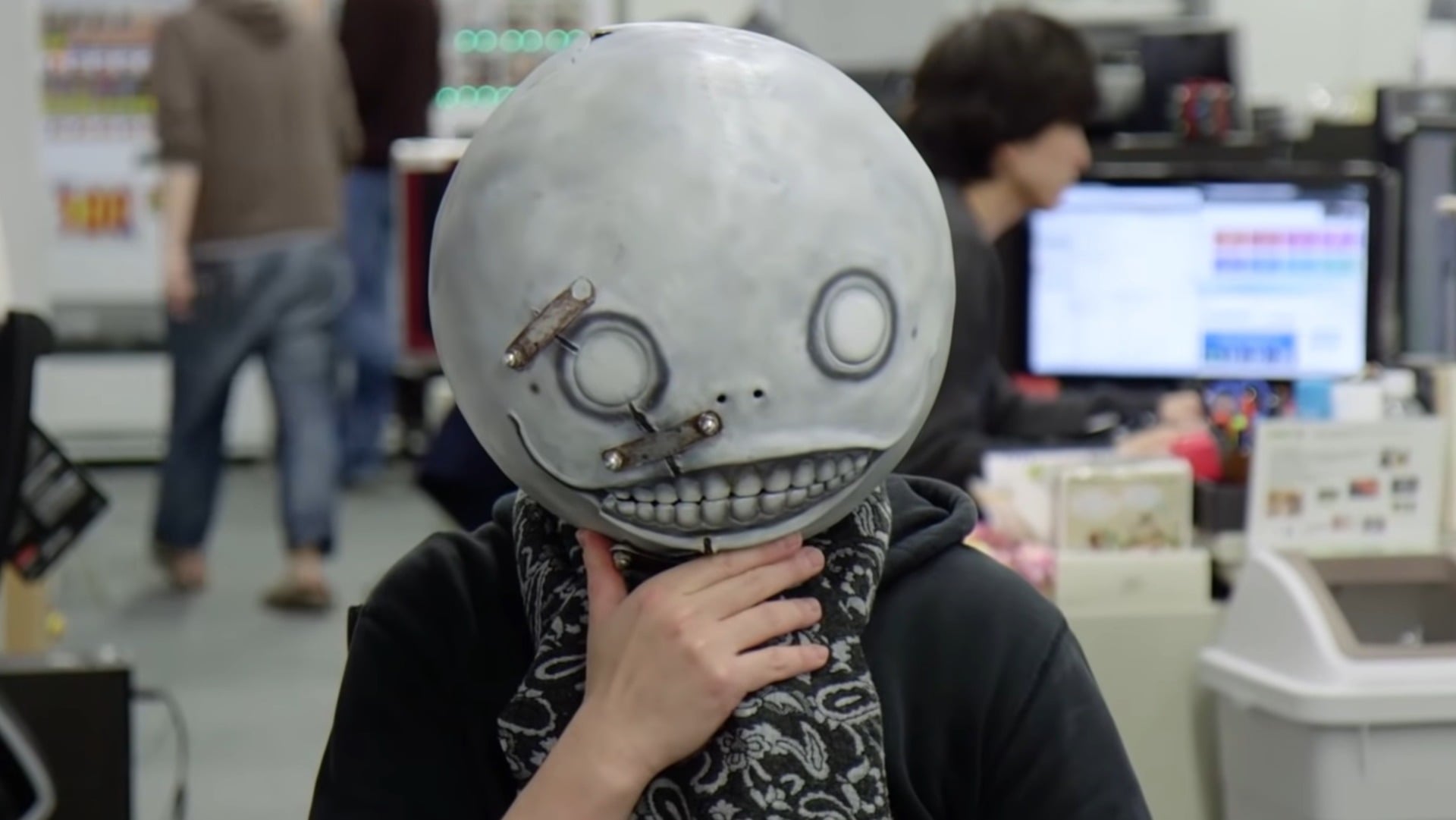Yoko Taro is wearing a spherical mask like Emil's from Nier.