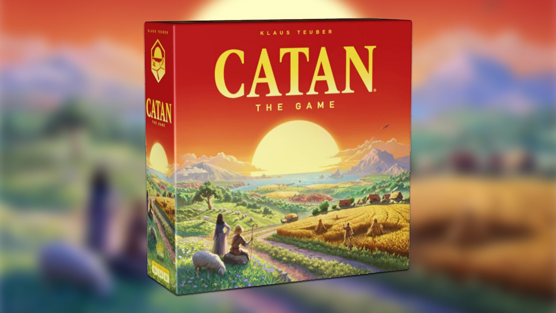 A box for Catan stands against a blurred background.