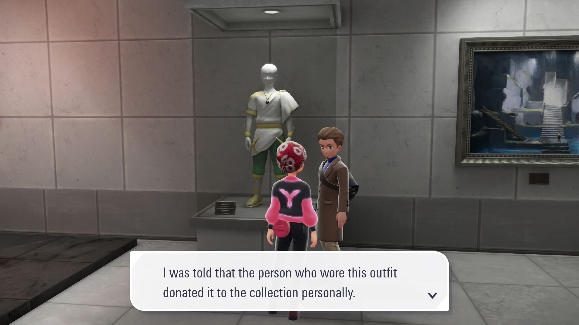 A person says "I was told that the person who wore this outfit donated it to the collection personally."