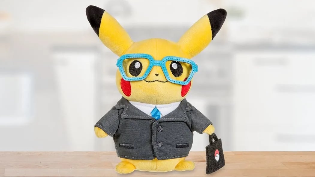 An Intern Pikachu plush wears a suit, glasses, and holds a briefcase.