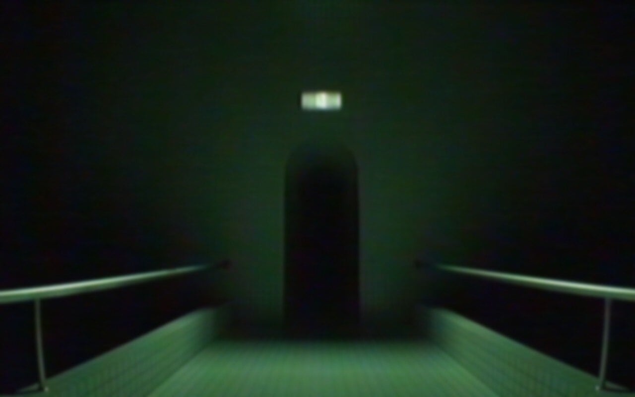 An ominous doorway stretches into blackness.