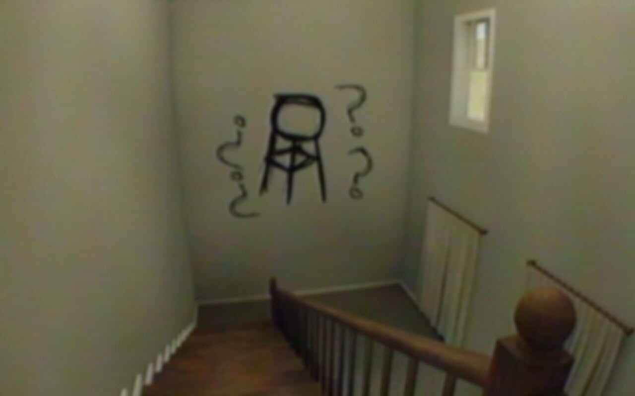 A strange symbol is written on a wall in an empty house.