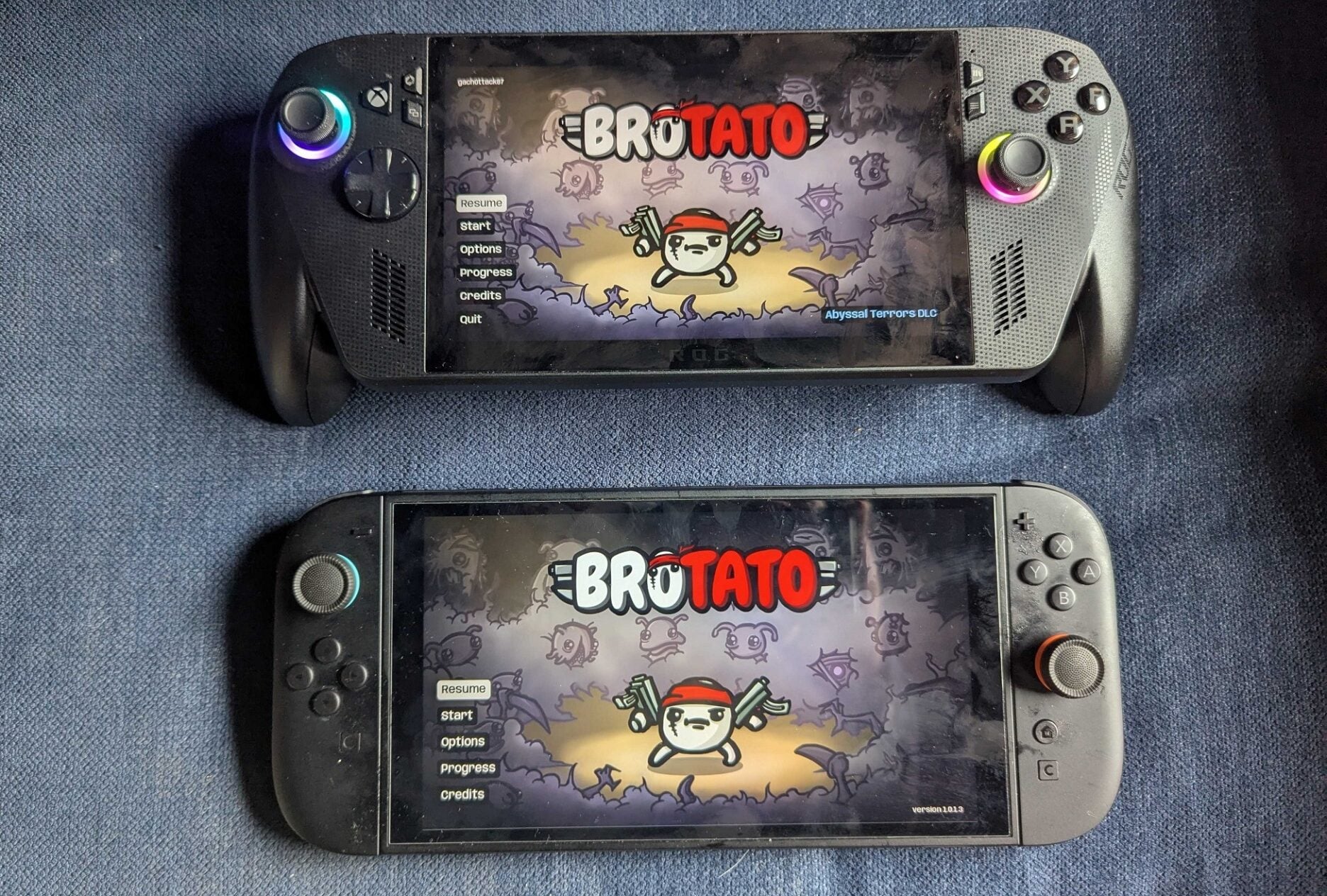 A Rog Ally X and Switch 2 sit on a couch.