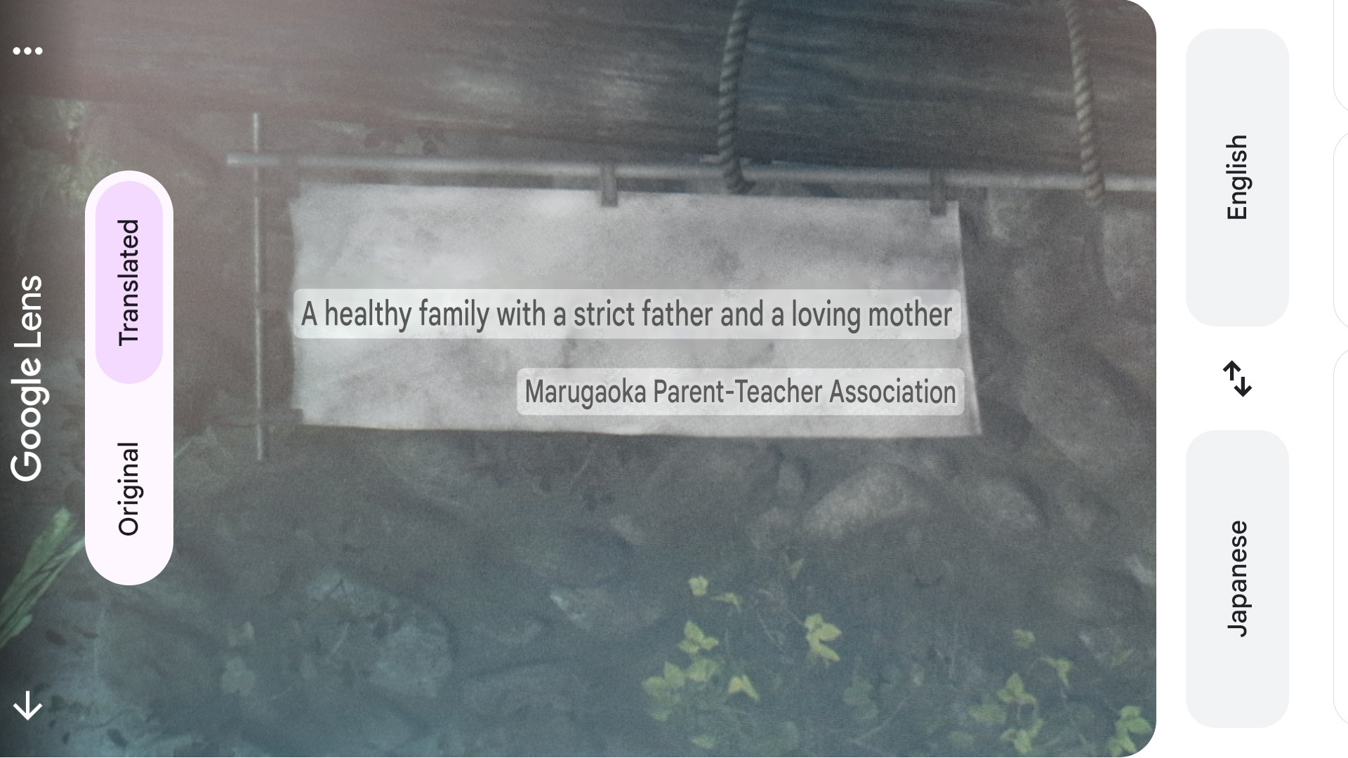 A screenshot of a sign in Silent Hill f read through Google Translate says:"A healthy family with a strict father and a loving mother. - Marugaoka Parent-Teacher Association