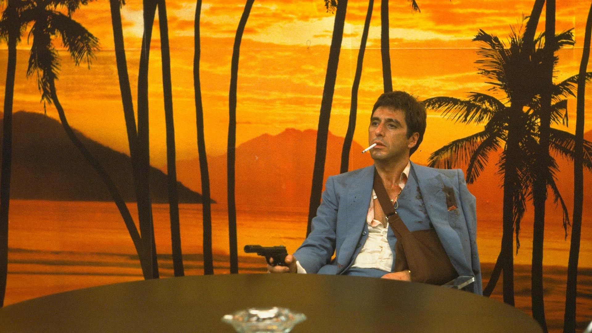 Tony Montana aims a pistol.