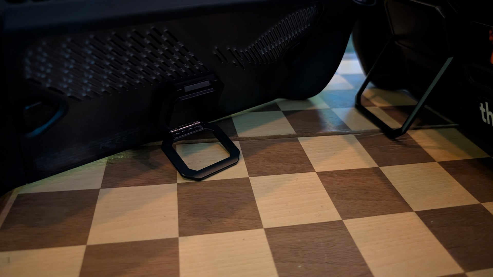 A Steam Deck and ROG Ally X sit on stands.