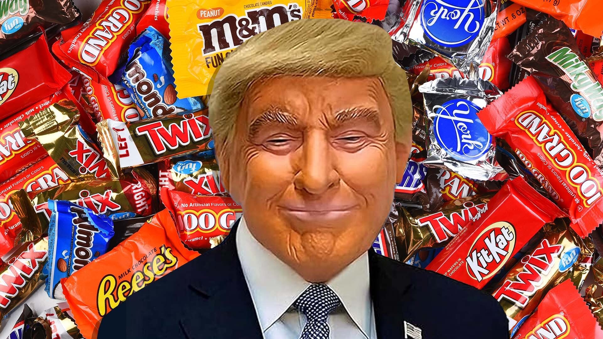 A Trump Halloween mask appears in front of candy.