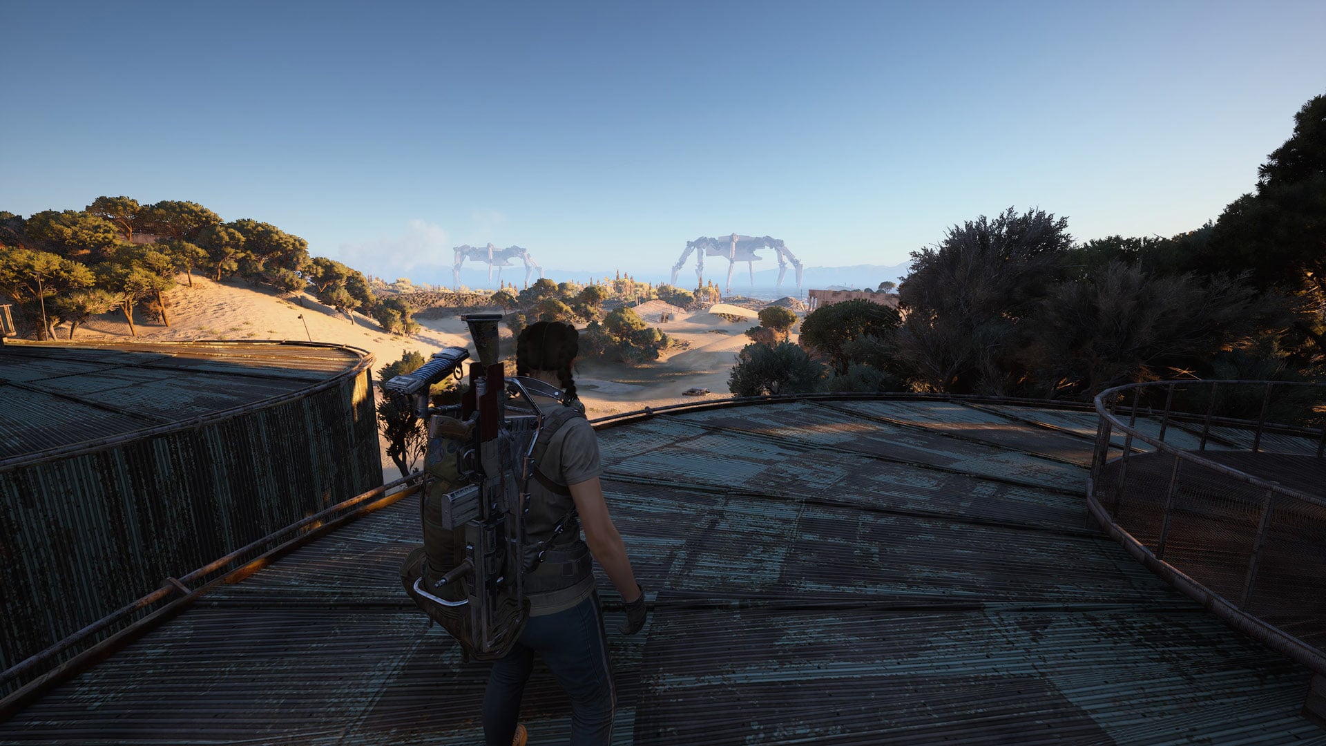 A player character looks out at distant massive robots.