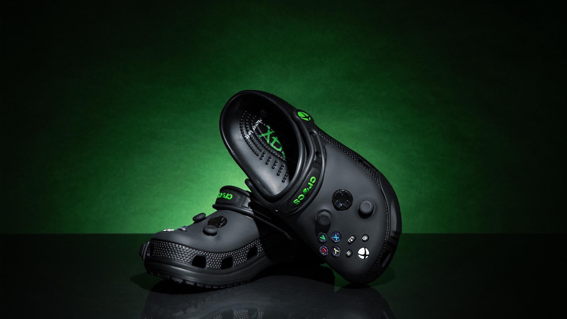 Xbox themed Crocs sit against a green gradient.