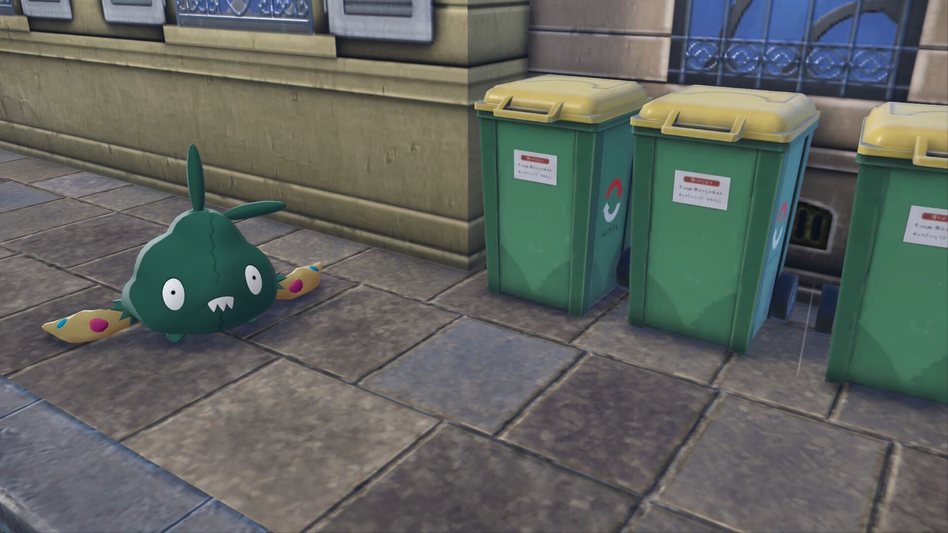 Trubbish stands next to garbage cans.