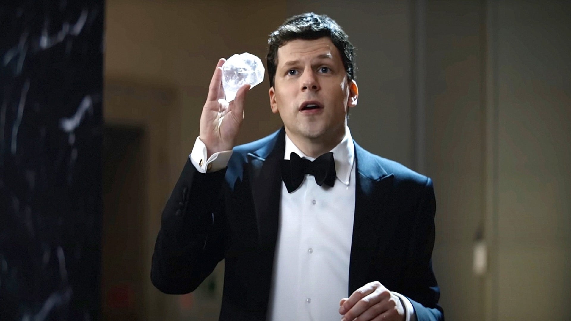 Jesse Eisenberg holding a diamond.