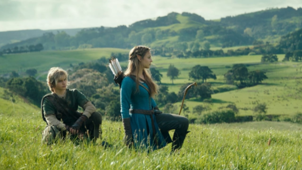 Link and Zelda stand in a field.