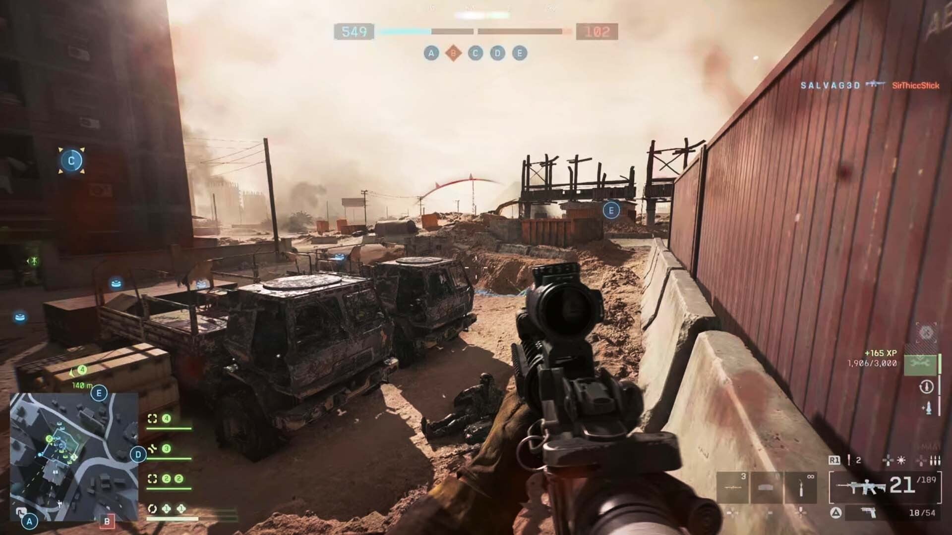 A gun is held up at a shipping container.