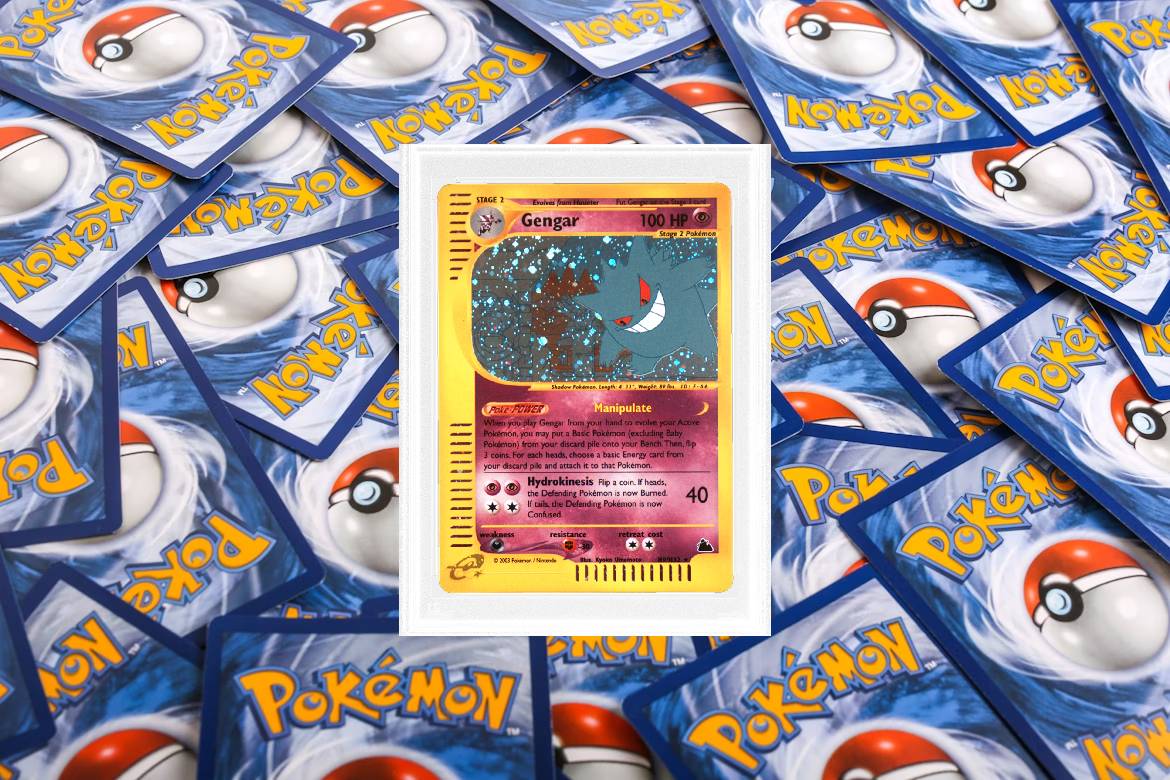A Gengar card sits on a pile of other Pokémon cards.