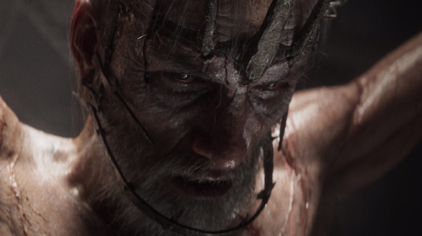 A man is tortured with a crown of thorns.