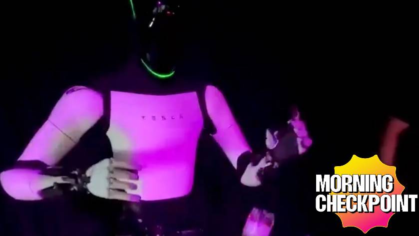 A Tesla robot appears at a night club.