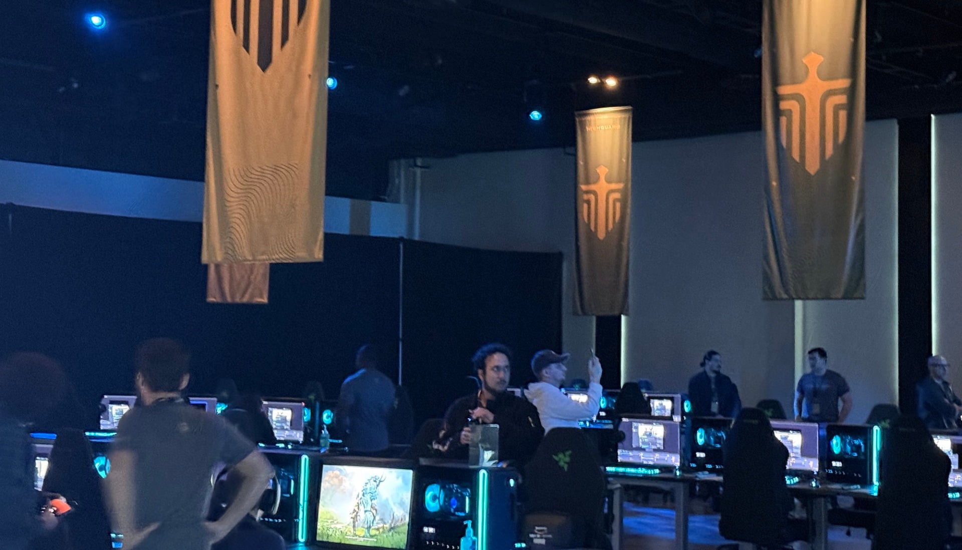 Game banners hang from a ceiling. 