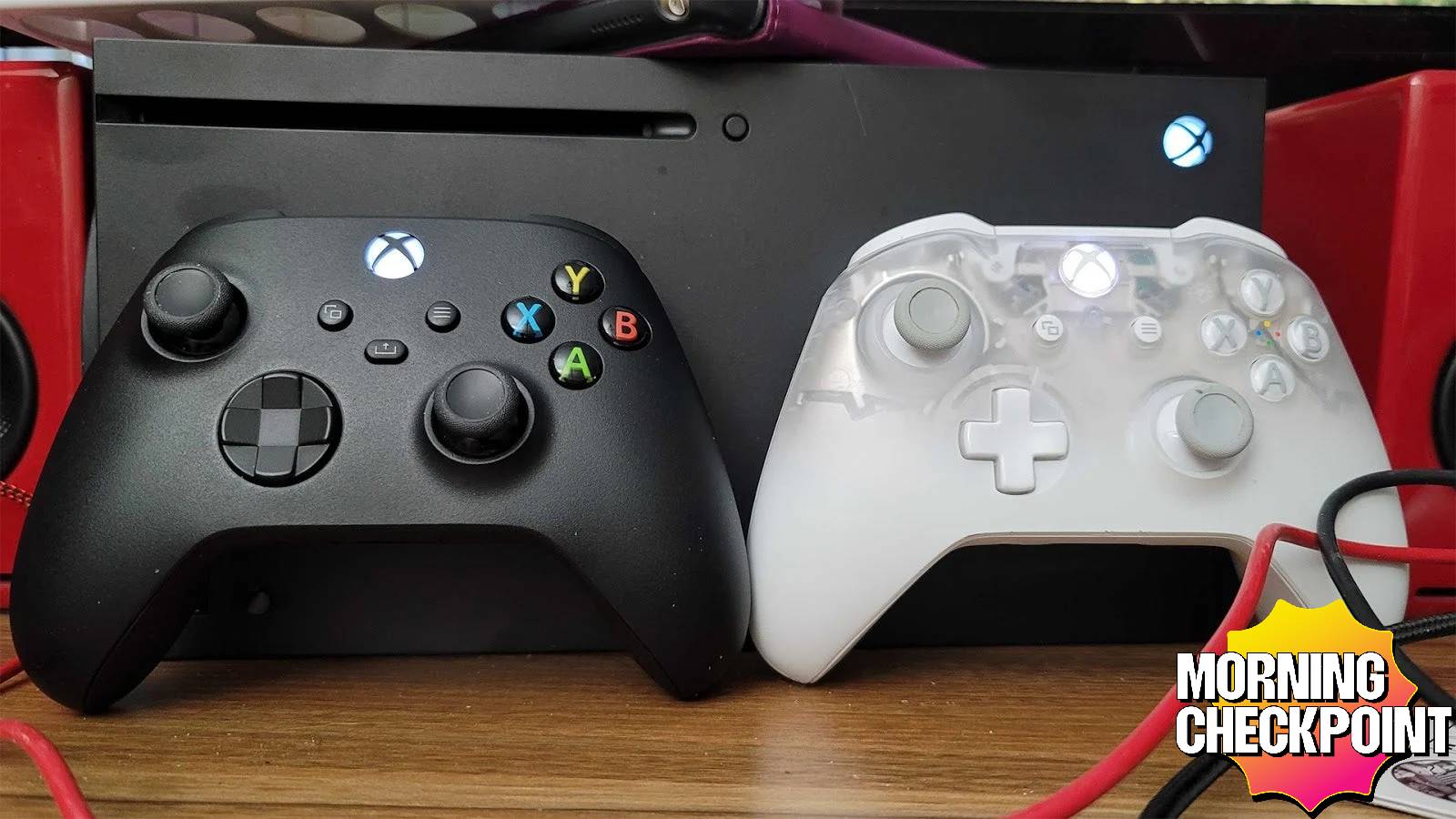 Xbox controllers sit in front of the console.