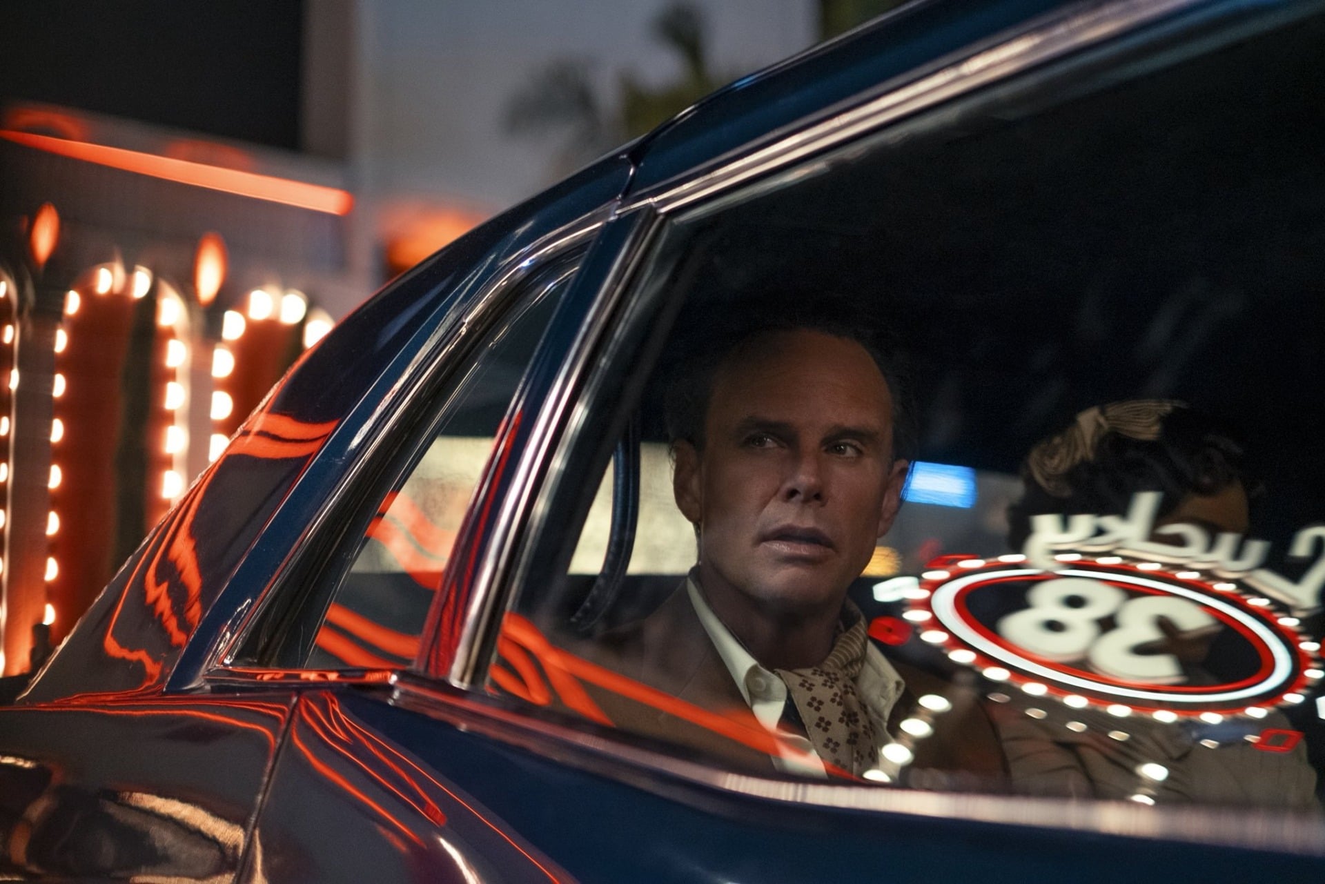 Walton Goggins looks out from a car.