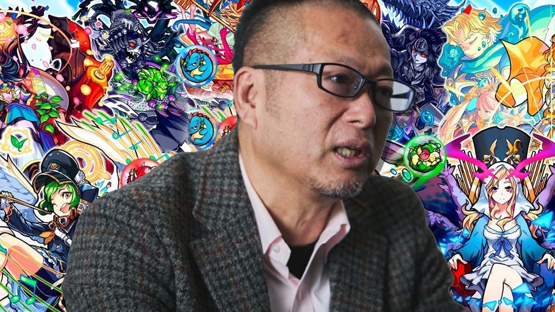 A man talks in front of art for Monster Strike.