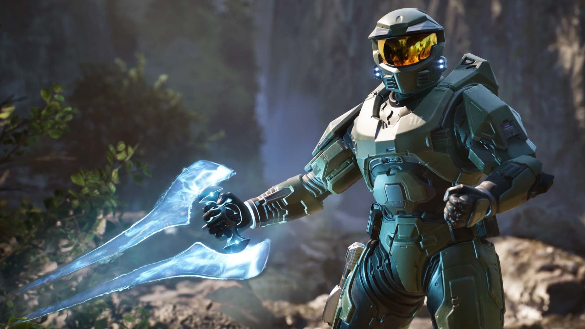 Master Chief holds an energy weapon.