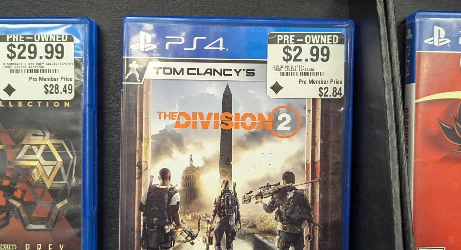 A copy of The Division 2 for PS4 sits on a shelf.