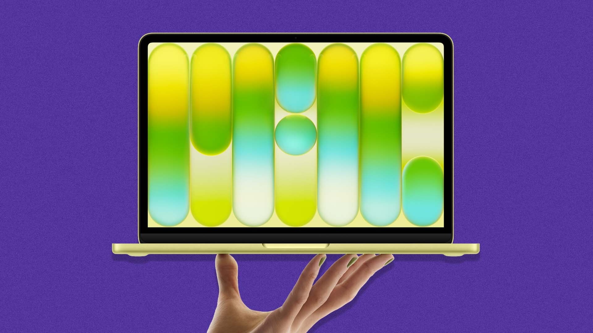 A hand holds up a MacBook Neo.