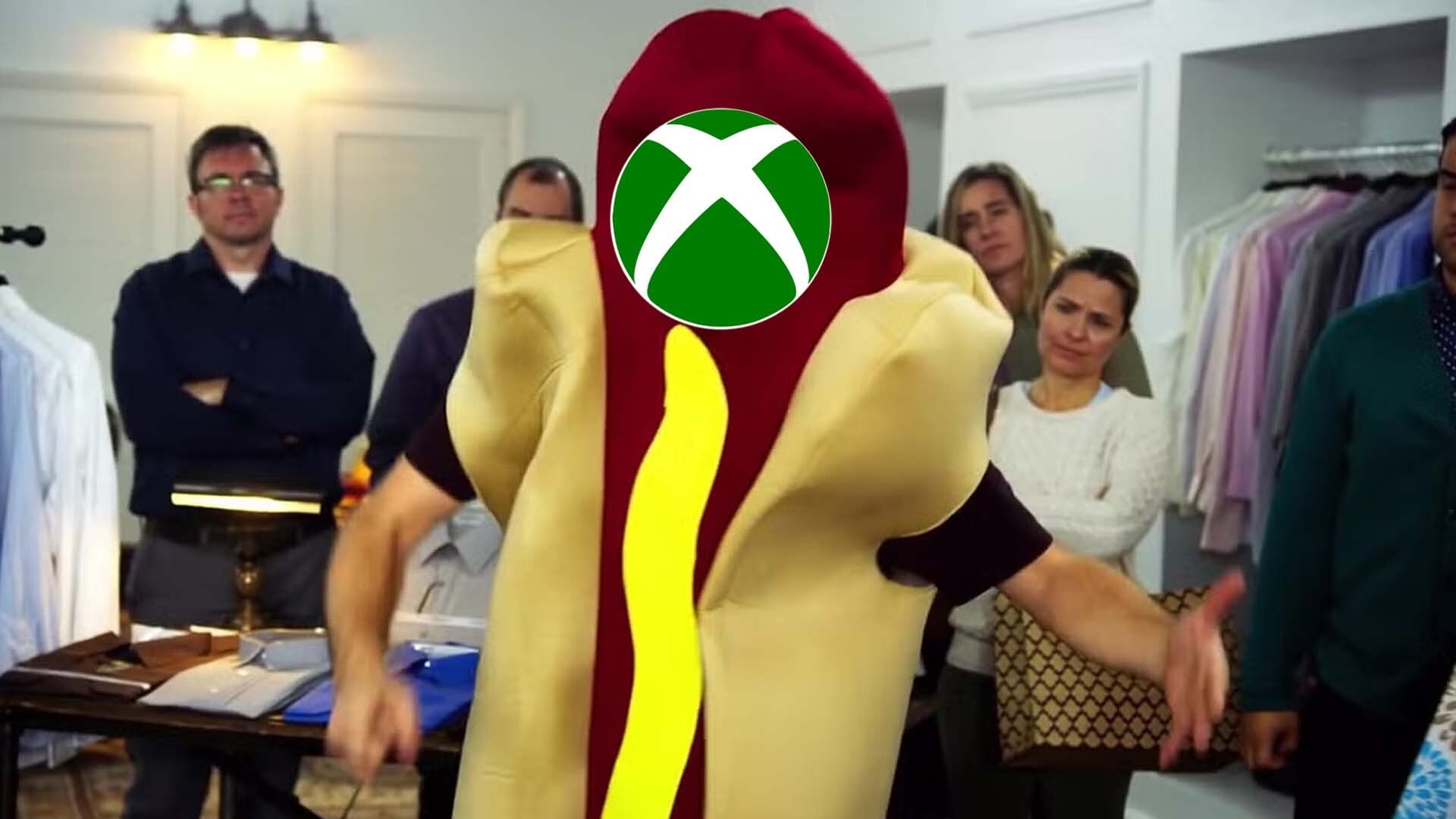 A guy in a hot dog suit has an Xbox logo for a face.